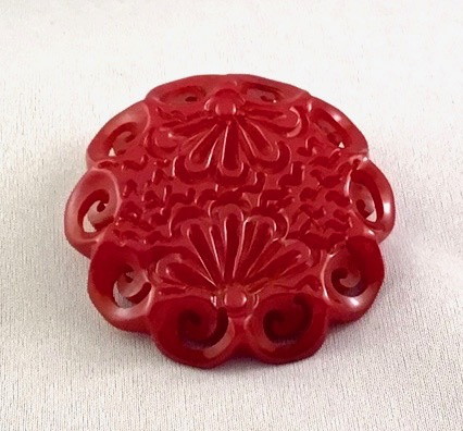 BP295 round red carved bakelite pin